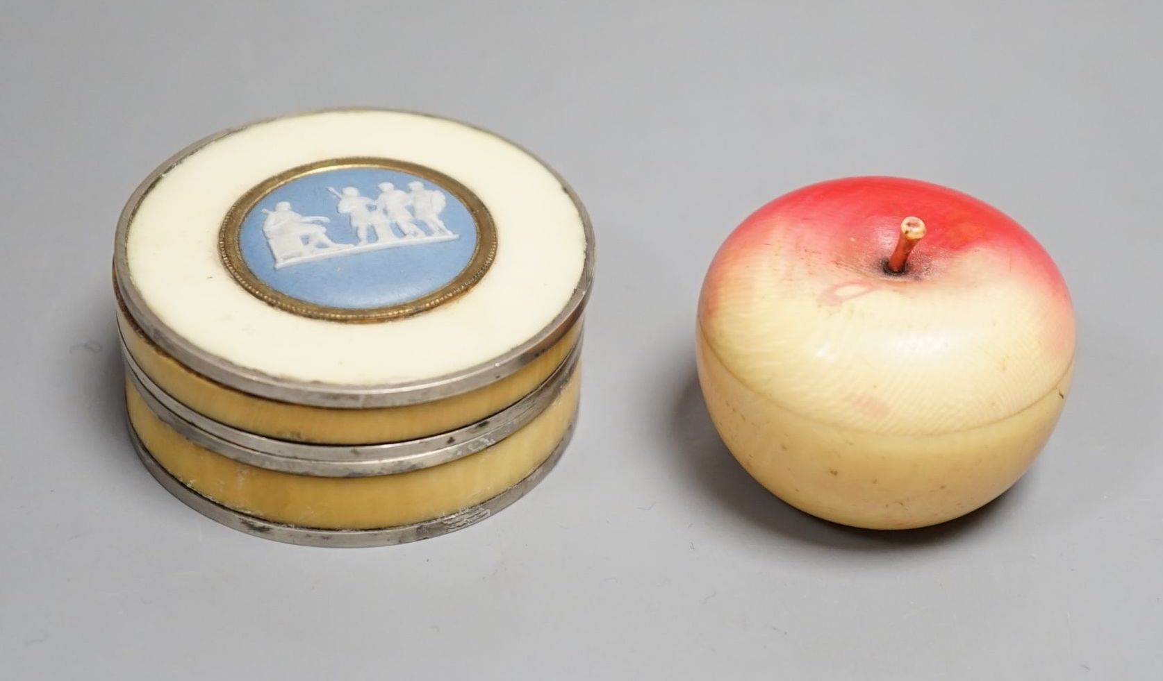 An early 19th century Ivory and blue Jasper mounted box and a 19th century coloured ivory box in the form of an apple (2) largest 5.5cm diameter